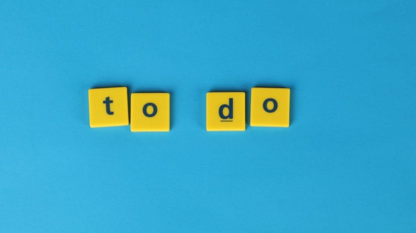 Yellow letter tiles spelling 'to do' against a vibrant blue background for organizational themes.